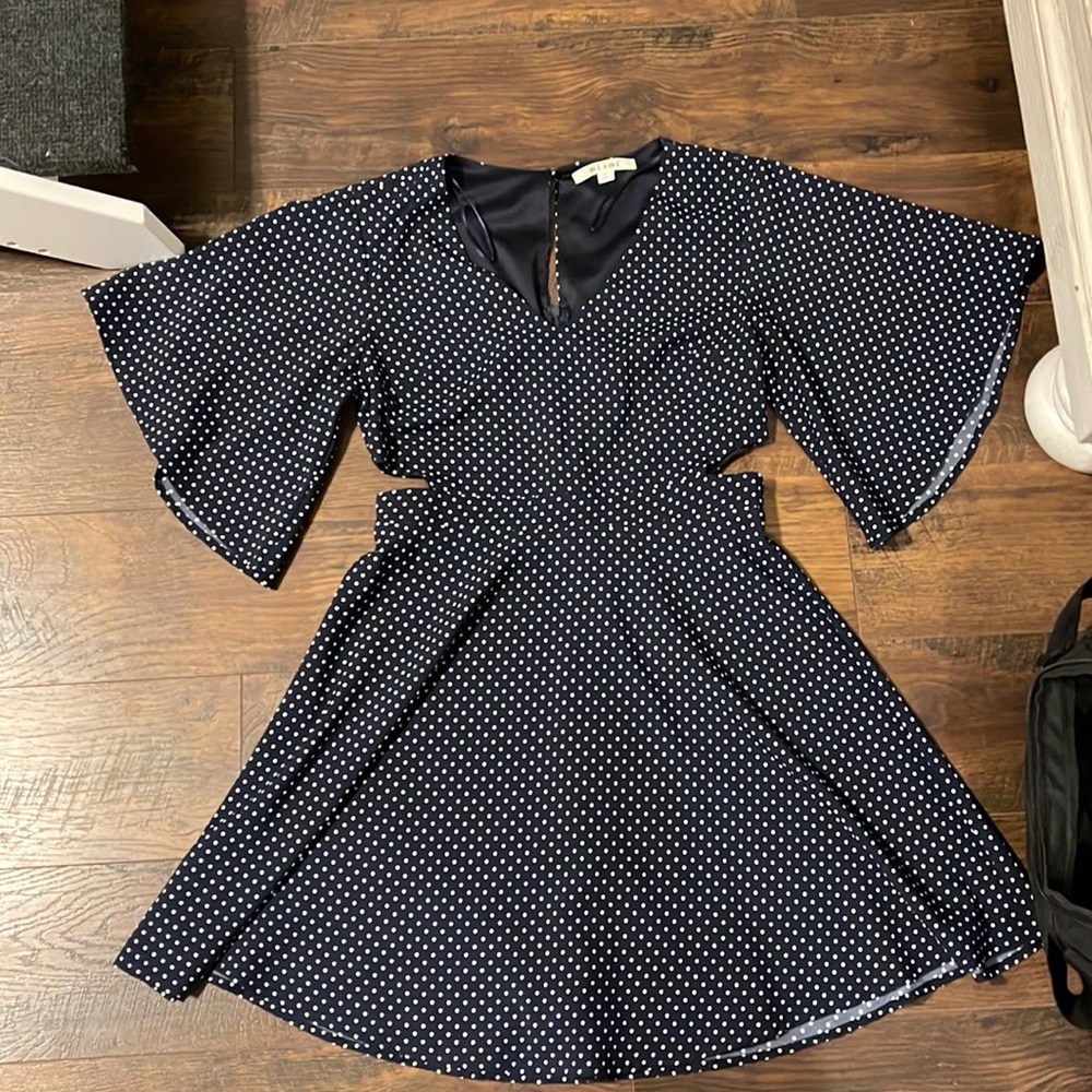 Navy polka dot babydoll dress with cut outs and keyhole back